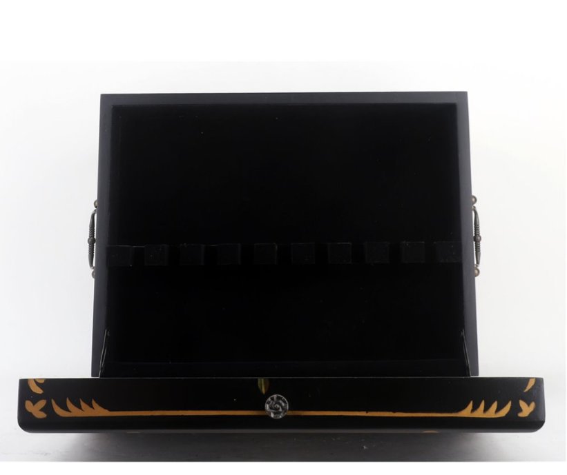Black jewelry box with gold accents on a white background