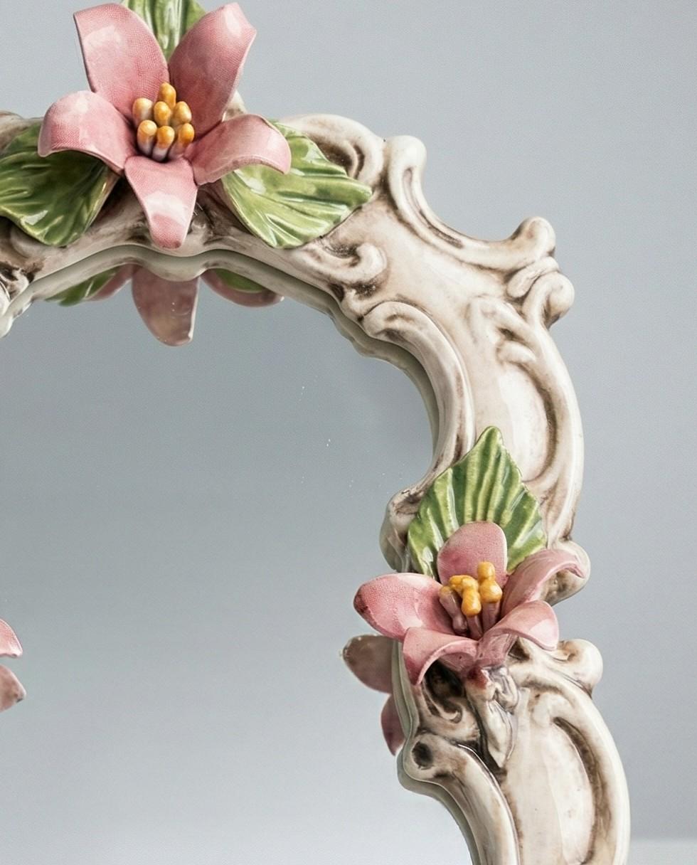 https://chairish-prod.freetls.fastly.net/image/product/master/225e54eb-93f5-4b2e-8774-3d842ba5b53b/vintage-capodimonte-italy-porcelain-floral-vanity-mirror-pink-flowers-145-2169