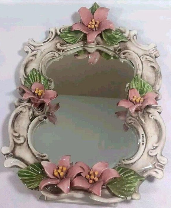 https://chairish-prod.freetls.fastly.net/image/product/master/ee336f28-bd56-47b6-983a-8e57235d133c/vintage-capodimonte-italy-porcelain-floral-vanity-mirror-pink-flowers-145-3391