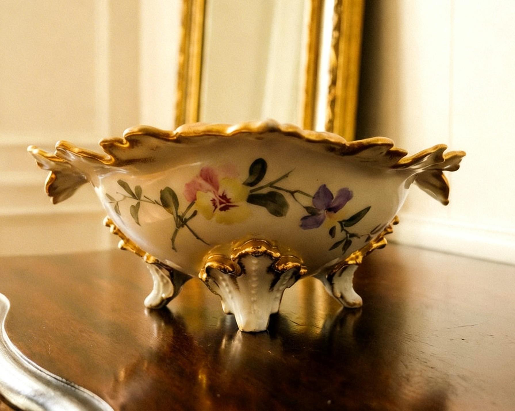 https://chairish-prod.freetls.fastly.net/image/product/master/b97baea6-f958-46a2-b79a-c1a8c5a2616c/vintage-hand-painted-hollywood-regency-porcelain-centerpiece-bowl-with-gilt-trim-and-floral-motif-2019